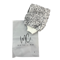 Car wash mitt with soapy water on paintwork