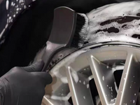 Tyre scrubbing brush removing brake dust and grime